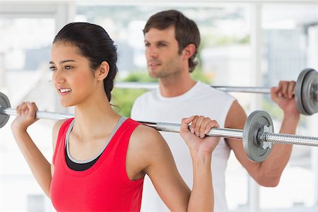 simsearch:400-07333355,k - Fit young man and woman lifting barbells in the gym Stock Photo - Budget Royalty-Free & Subscription, Code: 400-07333068