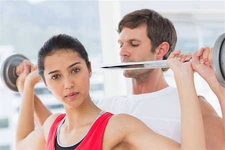 simsearch:400-06801591,k - Male trainer helping young fit woman to lift the barbell in the gym Stock Photo - Budget Royalty-Free & Subscription, Code: 400-07333062