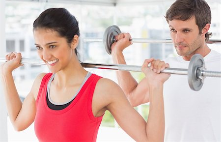 simsearch:400-06801597,k - Fit young man and woman lifting barbells in the gym Stock Photo - Budget Royalty-Free & Subscription, Code: 400-07333071