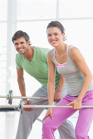 simsearch:400-06801591,k - Portrait of a fit young man and woman lifting barbells in the gym Foto de stock - Super Valor sin royalties y Suscripción, Código: 400-07333357