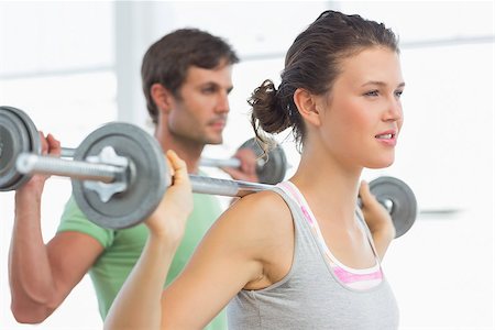 simsearch:400-06801591,k - Fit young man and woman lifting barbells in the gym Stock Photo - Budget Royalty-Free & Subscription, Code: 400-07333358