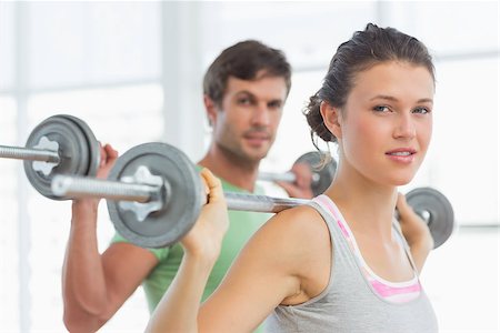 simsearch:400-06801591,k - Fit young man and woman lifting barbells in the gym Stock Photo - Budget Royalty-Free & Subscription, Code: 400-07333359