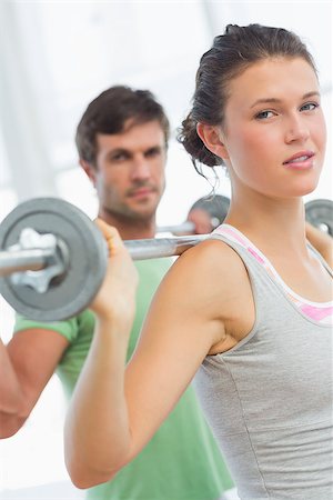 simsearch:400-06801591,k - Fit young man and woman lifting barbells in the gym Foto de stock - Super Valor sin royalties y Suscripción, Código: 400-07333360