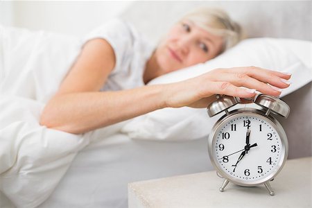 simsearch:614-02613098,k - Blurred sleepy mature woman extending hand to alarm clock in bed at home Stockbilder - Microstock & Abonnement, Bildnummer: 400-07333710