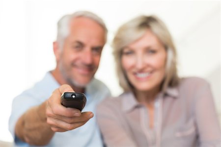 simsearch:400-04046300,k - Blurred happy mature couple watching tv on sofa at home Stock Photo - Budget Royalty-Free & Subscription, Code: 400-07333907