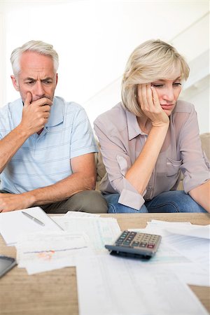 simsearch:400-07333928,k - Tensed mature man and woman with bills and calculator sitting on sofa at home Stock Photo - Budget Royalty-Free & Subscription, Code: 400-07333923