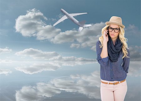 simsearch:400-07665599,k - Serious trendy blonde on the phone against peaceful water and sky Stock Photo - Budget Royalty-Free & Subscription, Code: 400-07344166