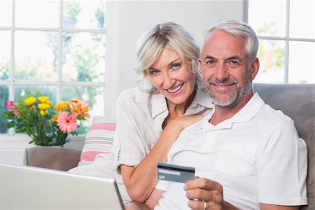 simsearch:400-07333971,k - Happy mature couple doing online shopping through laptop and credit card at home Stock Photo - Budget Royalty-Free & Subscription, Code: 400-07344202