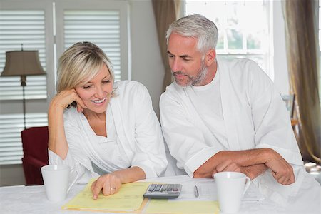 Casual mature couple sitting with home bills and calculator at table Stock Photo - Budget Royalty-Free & Subscription, Code: 400-07344389
