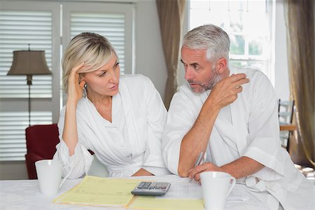 simsearch:400-07333928,k - Serious mature couple sitting with home bills and calculator at table Stock Photo - Budget Royalty-Free & Subscription, Code: 400-07344416