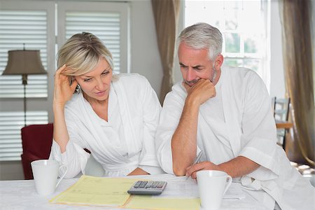 Thoughtful mature couple sitting with home bills and calculator at table Stock Photo - Budget Royalty-Free & Subscription, Code: 400-07344413