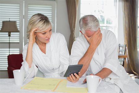 simsearch:400-07333928,k - Worried mature couple sitting with home bills and calculator at table Stock Photo - Budget Royalty-Free & Subscription, Code: 400-07344424