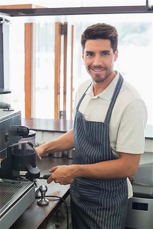 Portrait of a smiling young barista preparing espresso at coffee shop Stock Photo - Budget Royalty-Free & Subscription, Code: 400-07344935