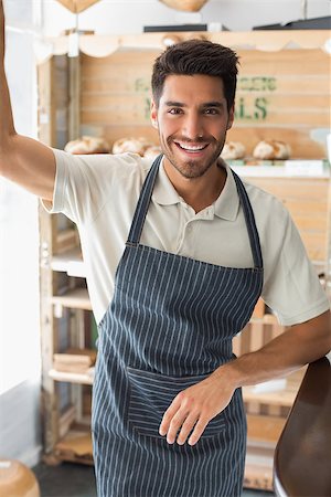 standing coffee bar - Portrait of a smiling confident young male barista standing at the coffee shop Stock Photo - Budget Royalty-Free & Subscription, Code: 400-07344943