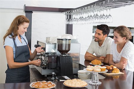 Side view of a smiling couple looking at waitress prepare coffee at the coffee shop Stock Photo - Budget Royalty-Free & Subscription, Code: 400-07345019