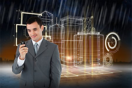 Smiling businessman looking at his cellphone against cityscape on the horizon Stock Photo - Budget Royalty-Free & Subscription, Code: 400-07345035