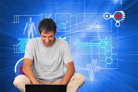simsearch:400-07346336,k - Bright man using a laptop against glowing background with squares Stock Photo - Budget Royalty-Free & Subscription, Code: 400-07345431