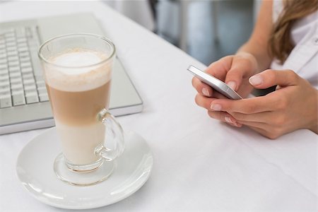 Close-up of a drink with hands using mobile phone on table in the coffee shop Stock Photo - Budget Royalty-Free & Subscription, Code: 400-07345457