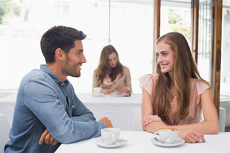 Smiling young couple having coffee at the coffee shop Stock Photo - Budget Royalty-Free & Subscription, Code: 400-07345534