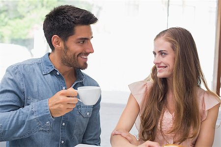 Smiling young couple having coffee at the coffee shop Stock Photo - Budget Royalty-Free & Subscription, Code: 400-07345540
