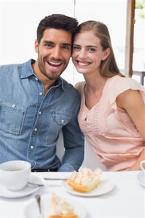 Portrait of a smiling young couple sitting at the coffee shop Stock Photo - Budget Royalty-Free & Subscription, Code: 400-07345552