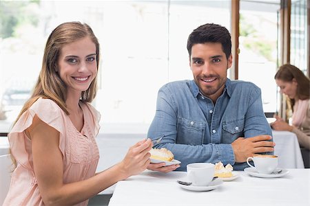 Portrait of a smiling young couple sitting at the coffee shop Stock Photo - Budget Royalty-Free & Subscription, Code: 400-07345567