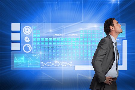 simsearch:400-07346336,k - Smiling businessman with hands on hips against glowing background with squares Stock Photo - Budget Royalty-Free & Subscription, Code: 400-07345847