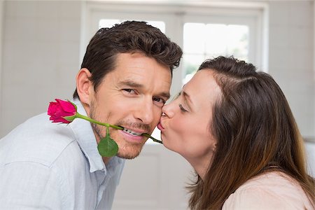 simsearch:400-07346120,k - Side view of a loving young woman kissing man at home Foto de stock - Super Valor sin royalties y Suscripción, Código: 400-07346125