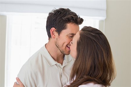 simsearch:400-07346120,k - Side view of a loving young couple kissing at home Foto de stock - Super Valor sin royalties y Suscripción, Código: 400-07346455