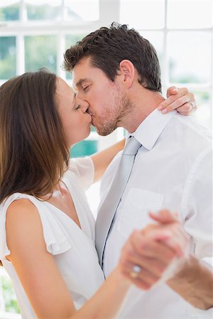 simsearch:400-07346120,k - Side view of a loving young couple kissing at home Foto de stock - Super Valor sin royalties y Suscripción, Código: 400-07346733