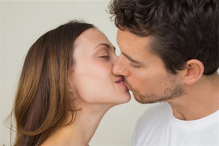 simsearch:400-07346120,k - Side view of a loving young couple kissing at home Foto de stock - Super Valor sin royalties y Suscripción, Código: 400-07346904