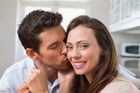 simsearch:400-07346120,k - Close-up of a loving young man kissing woman on cheek at home Foto de stock - Super Valor sin royalties y Suscripción, Código: 400-07347077