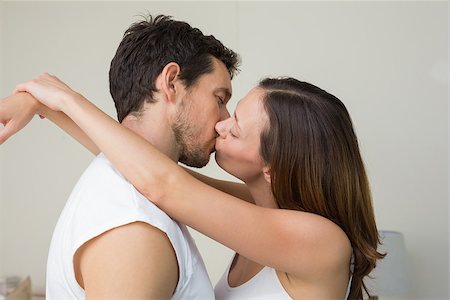 simsearch:400-07346120,k - Side view of a loving young couple kissing at home Foto de stock - Super Valor sin royalties y Suscripción, Código: 400-07347139