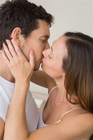 simsearch:400-07346120,k - Side view of a loving young couple kissing at home Foto de stock - Super Valor sin royalties y Suscripción, Código: 400-07347179