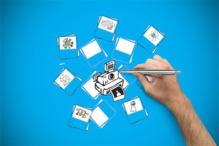 simsearch:400-07339684,k - Hand holding a silver pen against blue background with vignette Stock Photo - Budget Royalty-Free & Subscription, Code: 400-07347838