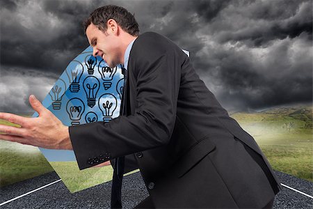 simsearch:400-07220030,k - Businessman posing with arms out against stormy landscape background with street Stock Photo - Budget Royalty-Free & Subscription, Code: 400-07340444