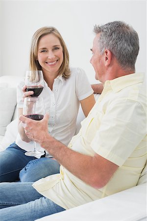 Happy relaxed couple with wine glasses sitting on sofa at home Stock Photo - Budget Royalty-Free & Subscription, Code: 400-07340453