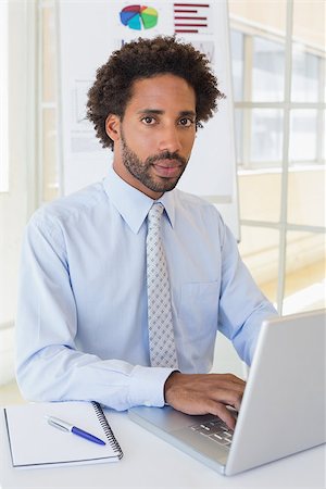 simsearch:400-07272682,k - Portrait of a young businessman using laptop at office desk Stockbilder - Microstock & Abonnement, Bildnummer: 400-07341191