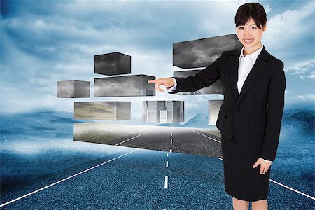 simsearch:400-07258416,k - Smiling businesswoman pointing against cloudy landscape background with street Stock Photo - Budget Royalty-Free & Subscription, Code: 400-07341560