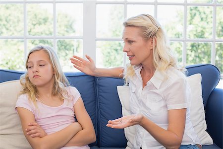 parent scolding kids - Mother scolding daughter while sitting on sofa at home Stock Photo - Budget Royalty-Free & Subscription, Code: 400-07341759