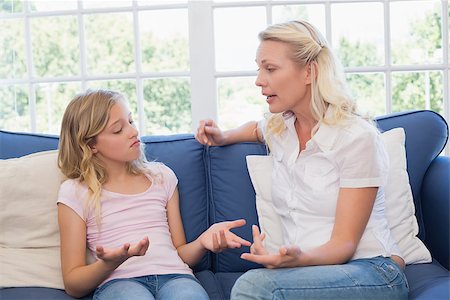 parent scolding kids - Angry mother scolding daughter while sitting on sofa at home Stock Photo - Budget Royalty-Free & Subscription, Code: 400-07341790