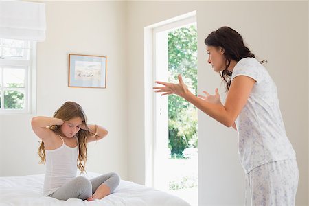 parent scolding kids - Little girl covering ears while mother scolding her in bedroom Stock Photo - Budget Royalty-Free & Subscription, Code: 400-07342101