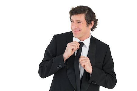 Happy groom adjusting necktie on white background Stock Photo - Budget Royalty-Free & Subscription, Code: 400-07342315