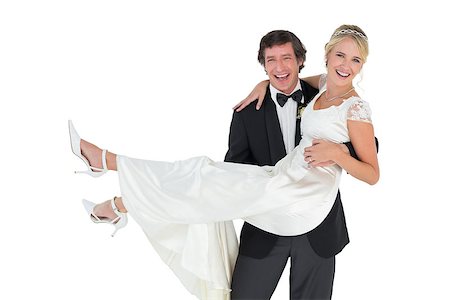 simsearch:400-07473236,k - Portrait of happy groom carrying bride isolates over white background Stockbilder - Microstock & Abonnement, Bildnummer: 400-07342378