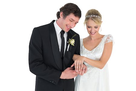 simsearch:400-07473236,k - Happy newlywed couple looking at wedding rings on white background Stockbilder - Microstock & Abonnement, Bildnummer: 400-07342372