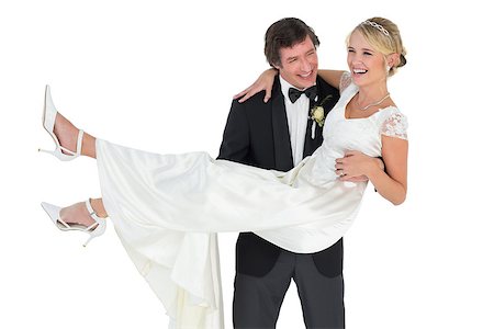 simsearch:400-07473236,k - Smiling groom carrying bride isolated over white background Stockbilder - Microstock & Abonnement, Bildnummer: 400-07342380