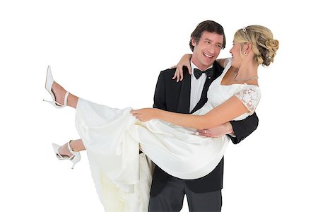 simsearch:400-07473236,k - Loving groom carrying bride isolated on white background Stockbilder - Microstock & Abonnement, Bildnummer: 400-07342383