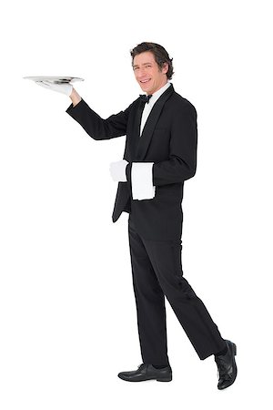 person and cut out and waiter - Full length portrait of server carrying tray isolated over white background Stock Photo - Budget Royalty-Free & Subscription, Code: 400-07342478