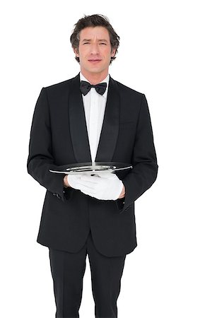 person and cut out and waiter - Portrait of confident waiter holding empty tray over white background Stock Photo - Budget Royalty-Free & Subscription, Code: 400-07342487