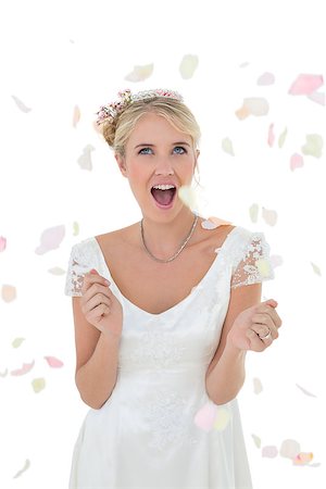 falling flower petals - Surprised young bride being showered with petals against white background Stock Photo - Budget Royalty-Free & Subscription, Code: 400-07342688